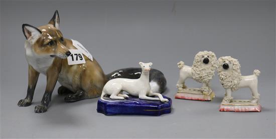 A Rosenthal fox and three assorted figures of dogs